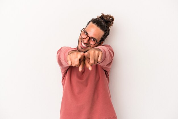 Young caucasian man isolated on white background pointing to front with fingers.