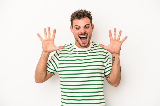 Young caucasian man isolated on white background receiving a pleasant surprise, excited and raising hands.