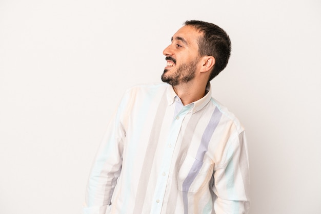 Young caucasian man isolated on white background relaxed and happy laughing, neck stretched showing teeth.