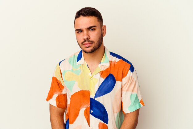 Young caucasian man isolated on white background sad, serious face, feeling miserable and displeased.