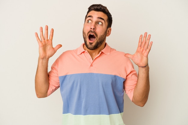 Young caucasian man isolated on white background screaming to the sky, looking up, frustrated.