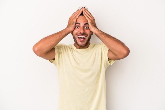 Young caucasian man isolated on white background screaming, very excited, passionate, satisfied with something.