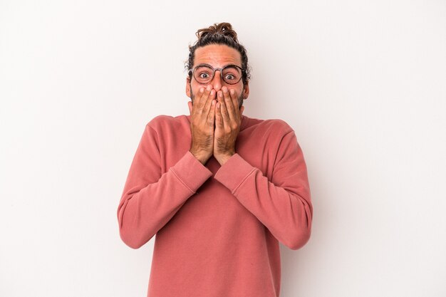 Young caucasian man isolated on white background shocked, covering mouth with hands, anxious to discover something new.