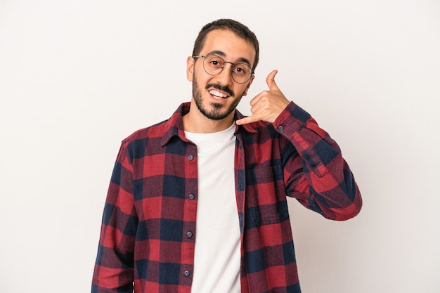 Young caucasian man isolated on white background showing a mobile phone call gesture with fingers.