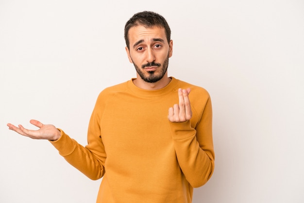 Young caucasian man isolated on white background showing that she has no money.