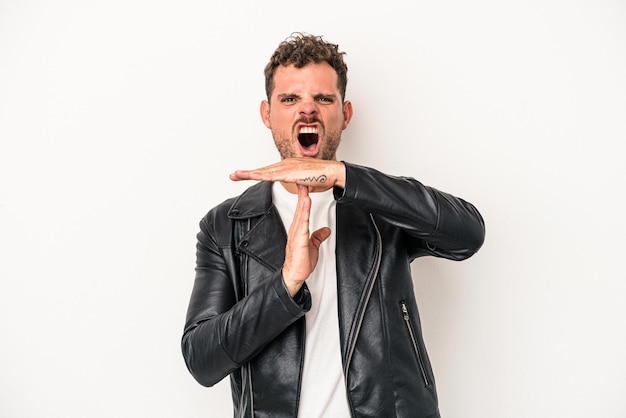 Young caucasian man isolated on white background showing a timeout gesture.