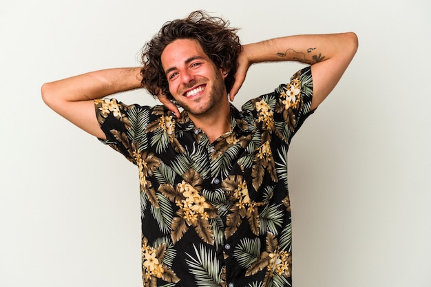 Young caucasian man isolated on white background stretching arms, relaxed position.