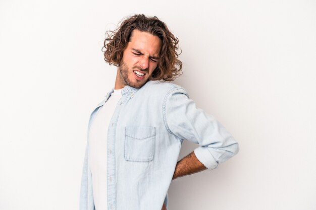 Young caucasian man isolated on white background suffering a back pain.