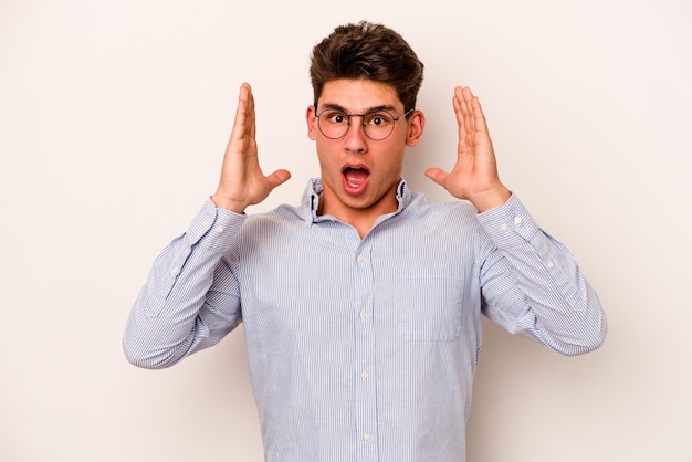 Young caucasian man isolated on white background surprised and shocked