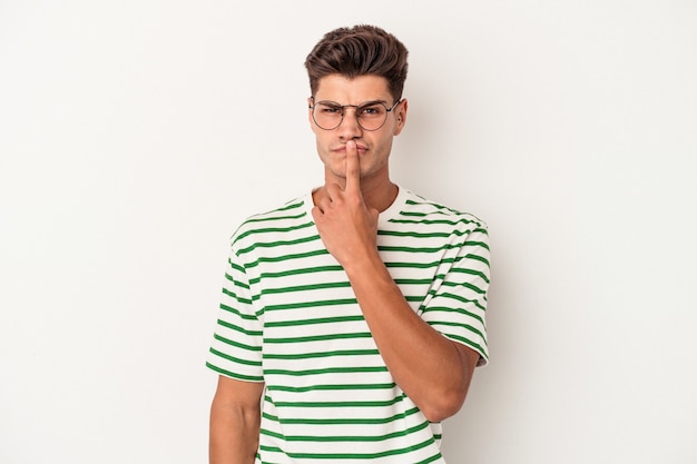 Young caucasian man isolated on white background thinking and looking up, being reflective, contemplating, having a fantasy.