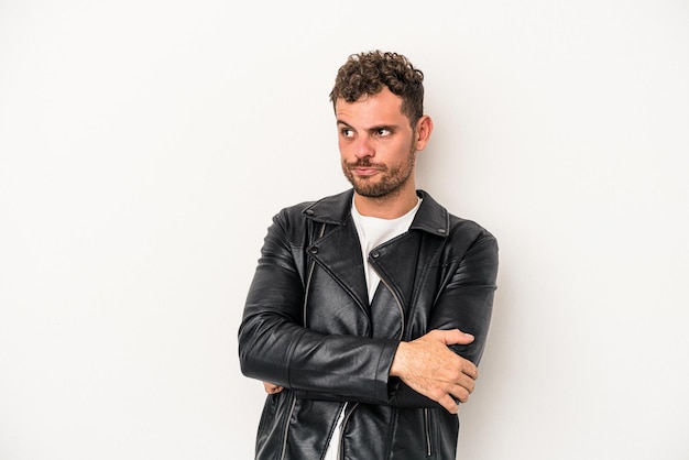 Young caucasian man isolated on white background tired of a repetitive task.