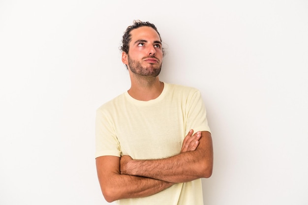 Young caucasian man isolated on white background tired of a repetitive task.