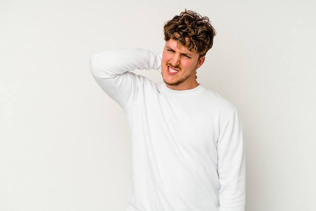 Young caucasian man isolated on white background tired and very sleepy keeping hand on head.