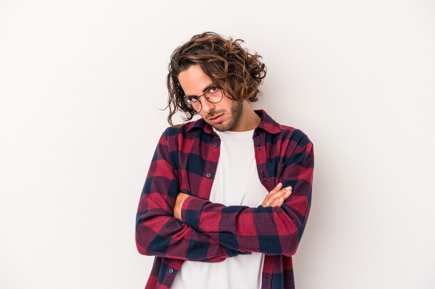 Young caucasian man isolated on white background who is bored, fatigued and need a relax day.