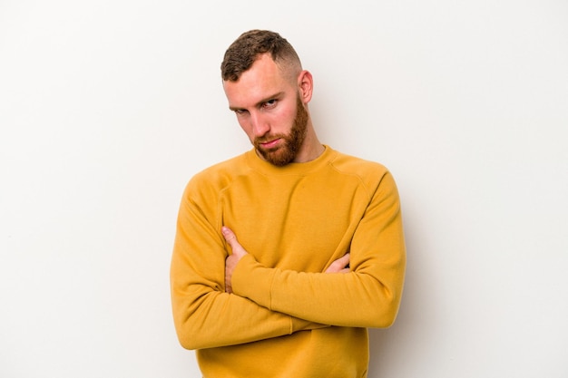 Young caucasian man isolated on white background who is bored, fatigued and need a relax day.