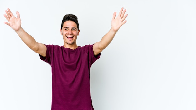 Young caucasian man isolated on white celebrating a victory or success, he is surprised and shocked.