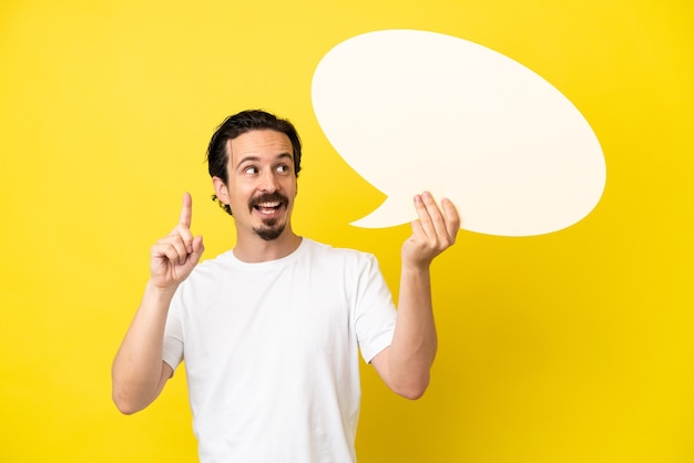 Young caucasian man isolated on yellow background holding an empty speech bubble and thinking