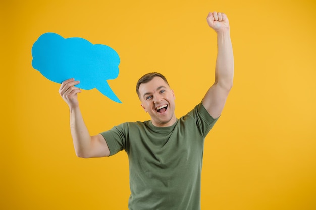 Young caucasian man isolated on yellow background holding a thinking speech bubble and doing OK sign