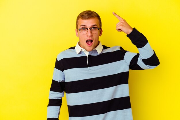 Young caucasian man isolated on yellow having some great idea, concept of creativity.