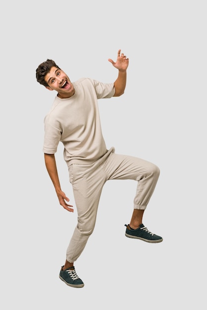 Young caucasian man jumping isolated on white background