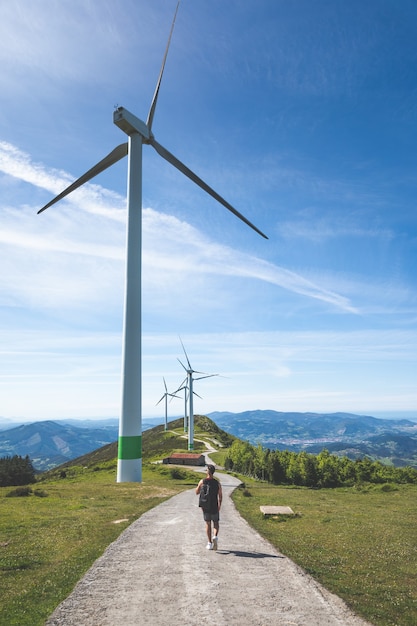 Young caucasian man near windmills at the top of Oiz mountain; Basque Country.