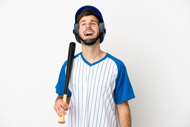 Young caucasian man playing baseball isolated on white background laughing