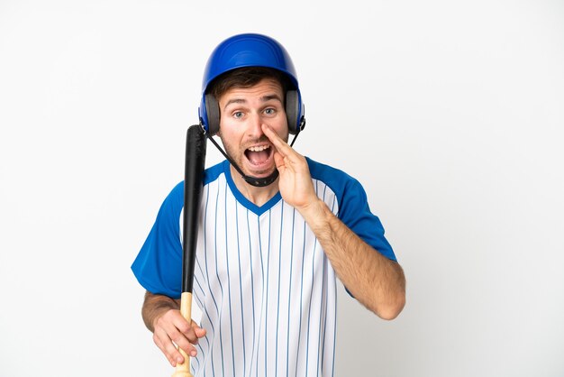 Young caucasian man playing baseball isolated on white background shouting with mouth wide open