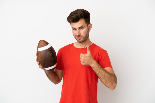 Young caucasian man playing rugby isolated on white background giving a thumbs up gesture