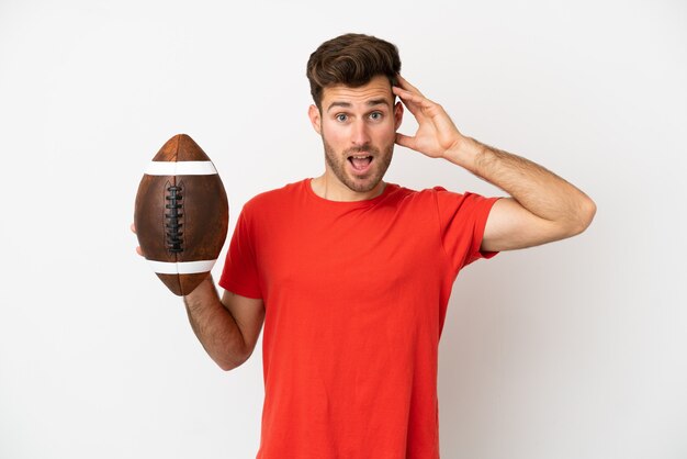 Photo young caucasian man playing rugby isolated on white background with surprise expression