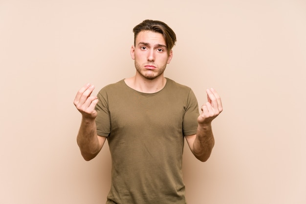 Young caucasian man posing isolated showing that she has no money.