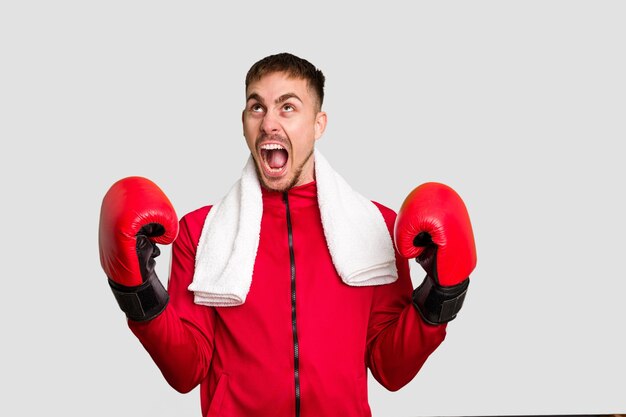 Young caucasian man practicing boxing cut out isolated