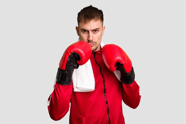 Young caucasian man practicing boxing cut out isolated