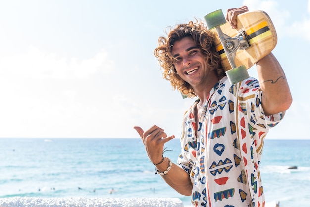 Young caucasian man practicing longboard on the beach