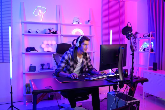 Young Caucasian man Pro Gamer have live streaming and chatting with his fans at home