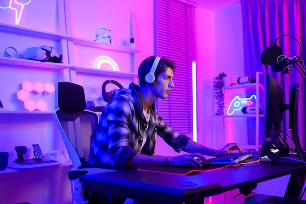 Young Caucasian man Pro Gamer have live streaming and chatting with his fans at home