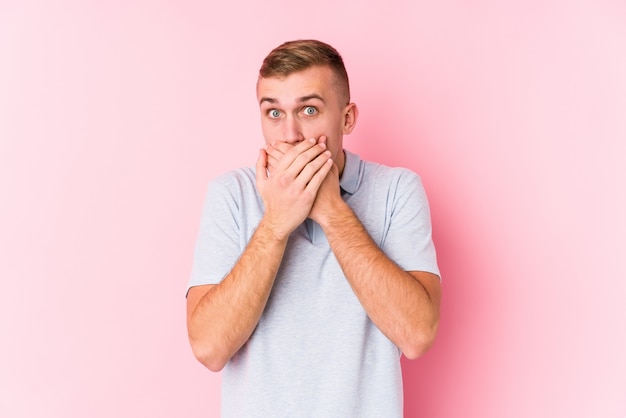 Young caucasian man shocked covering mouth with hands.