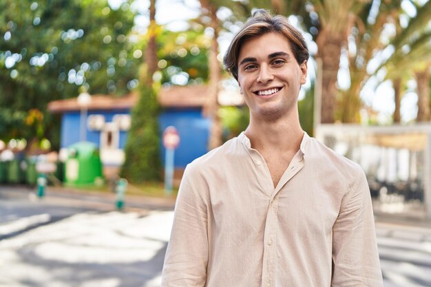 Young caucasian man smiling confident standing at street