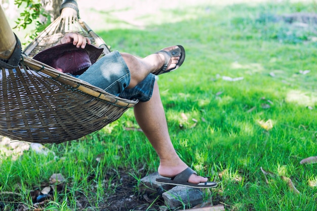 young caucasian man swinging in a hammock