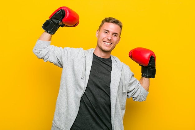 Young caucasian man wearing a boxing gloves