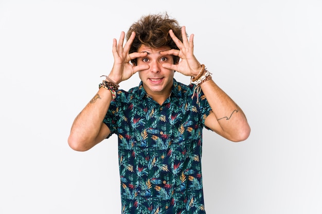 Young caucasian man wearing a flower t-shirt isolated keeping eyes opened to find a success opportunity.