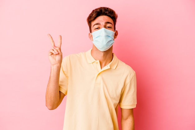 Young caucasian man wearing a protection for coronavirus isolated