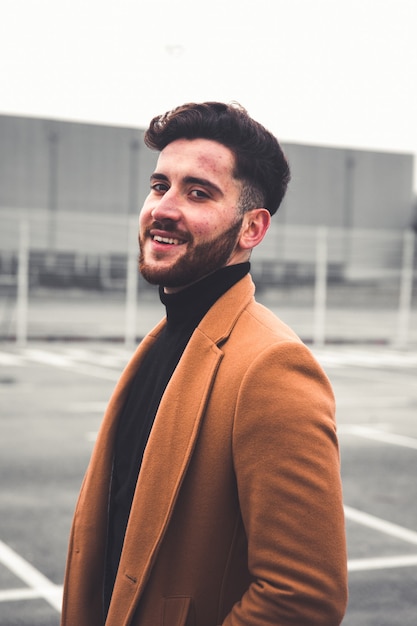 Young caucasian man with casual clothes at a parking lot