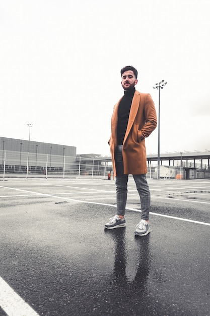 Young caucasian man with casual clothes at a parking lot