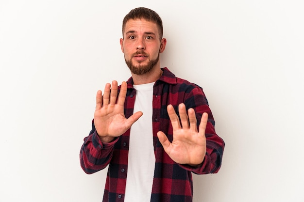 Young caucasian man with diastema isolated on white background being shocked due to an imminent danger