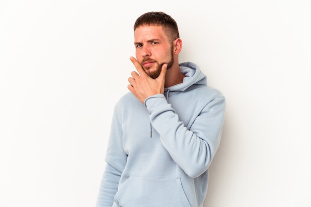 Young caucasian man with diastema isolated on white background contemplating, planning a strategy, thinking about the way of a business.