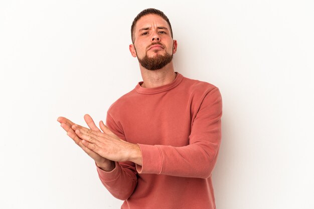 Young caucasian man with diastema isolated on white background feeling energetic and comfortable, rubbing hands confident.