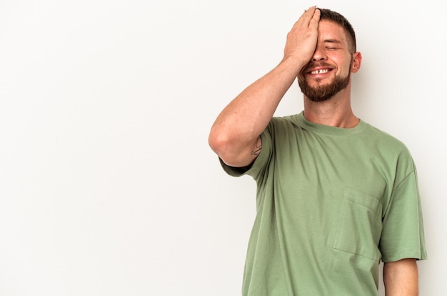 Young caucasian man with diastema isolated on white background laughing happy, carefree, natural emotion.