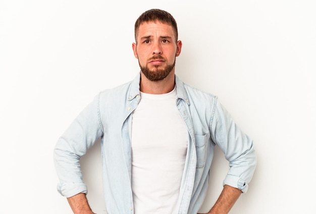 Young caucasian man with diastema isolated on white background sad, serious face, feeling miserable and displeased.