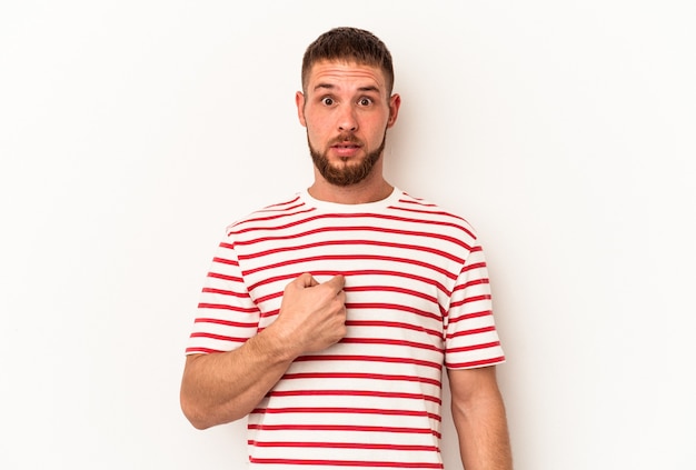 Young caucasian man with diastema isolated on white background surprised pointing with finger, smiling broadly.