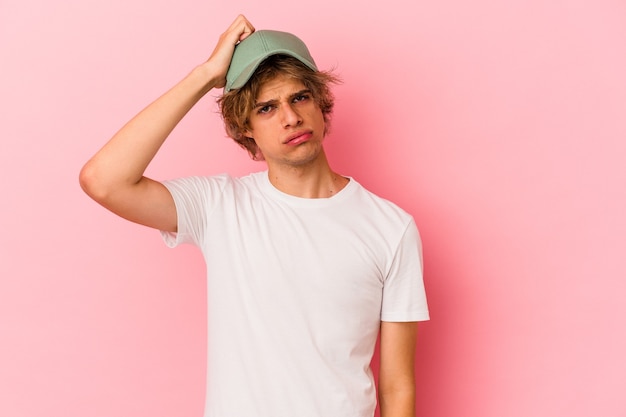 Young caucasian man with make up isolated on pink background tired and very sleepy keeping hand on head.